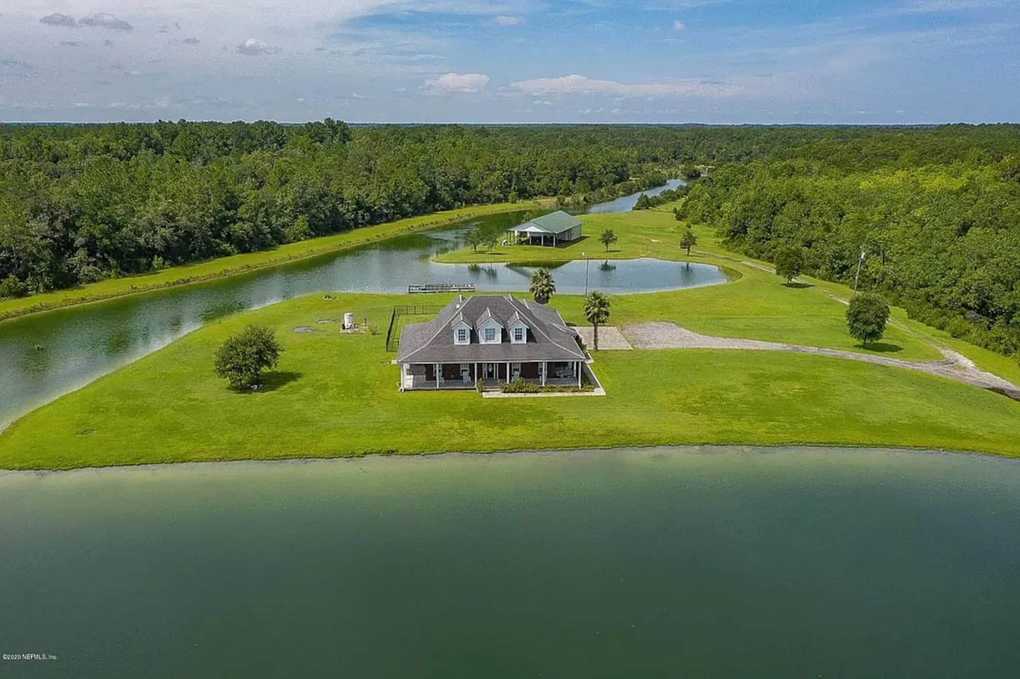 Aerial view of the estate, the private pond looping around it