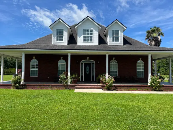 The front of the house, with its wrap-around porch and dormer windows